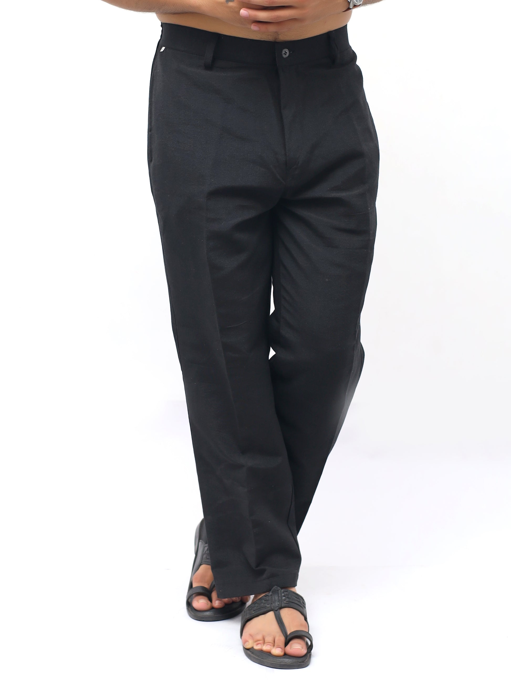 Black pants worn by a person on a white background