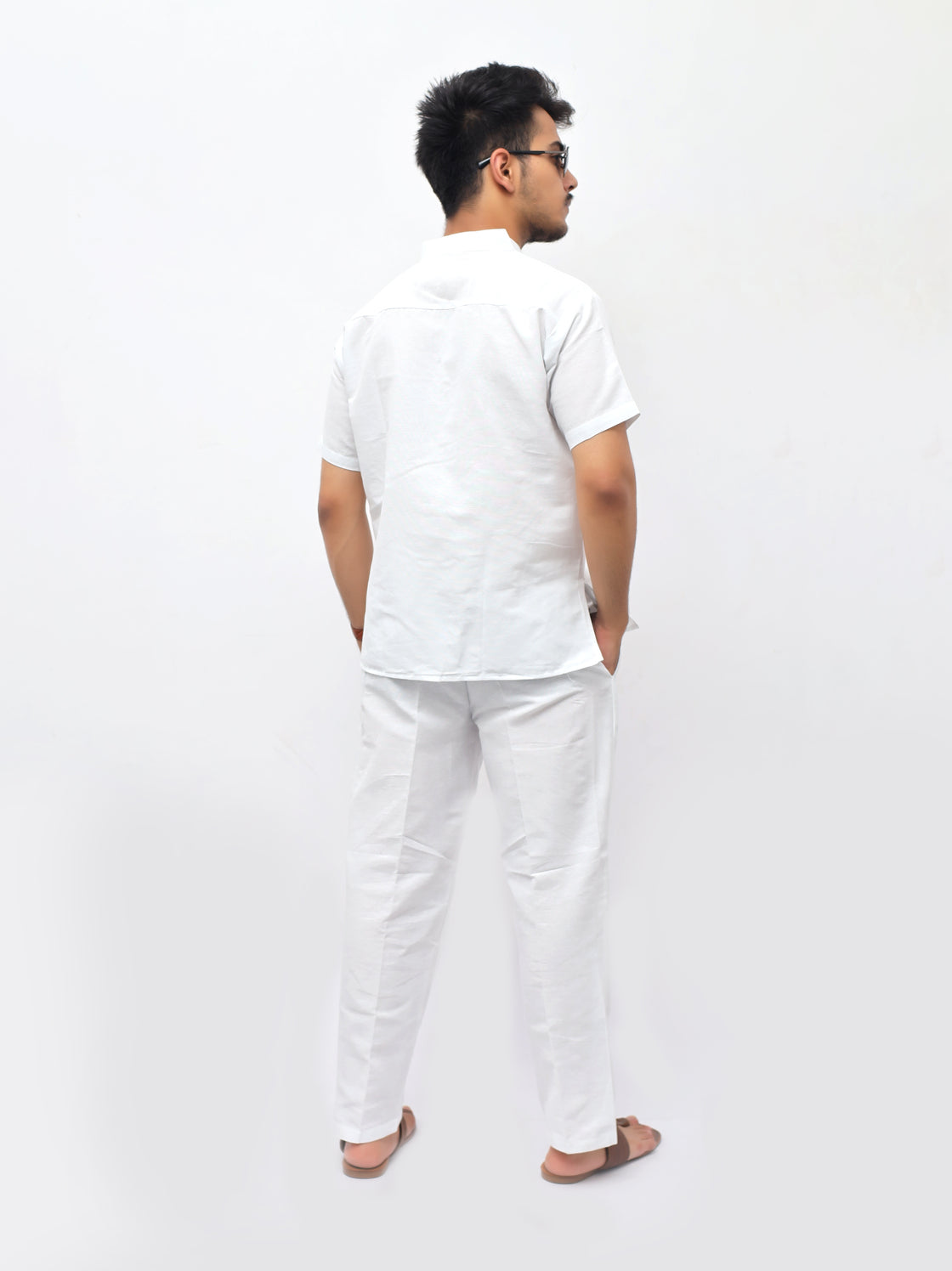 Person wearing a white outfit on a plain background