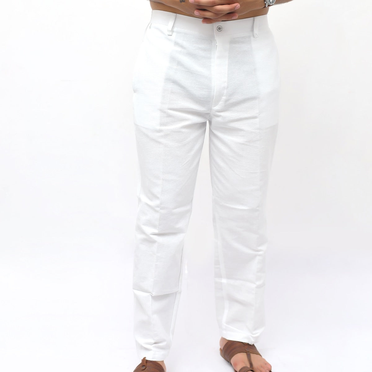 White pants worn by a person on a white background