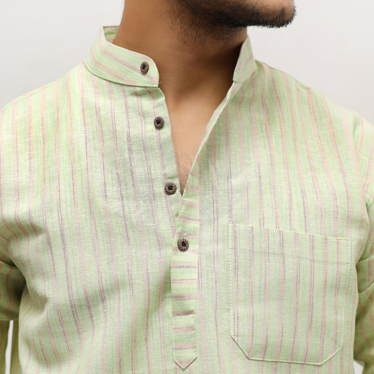 Light green shirt with pink stripes worn by a person on a plain background