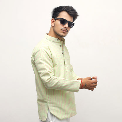 Man wearing a light green shirt and sunglasses on a white background