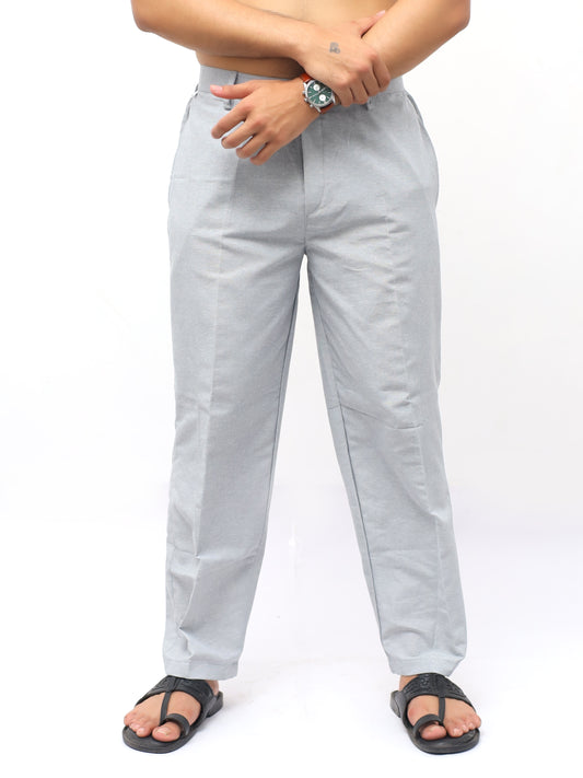 Light gray pants worn by a person on a white background